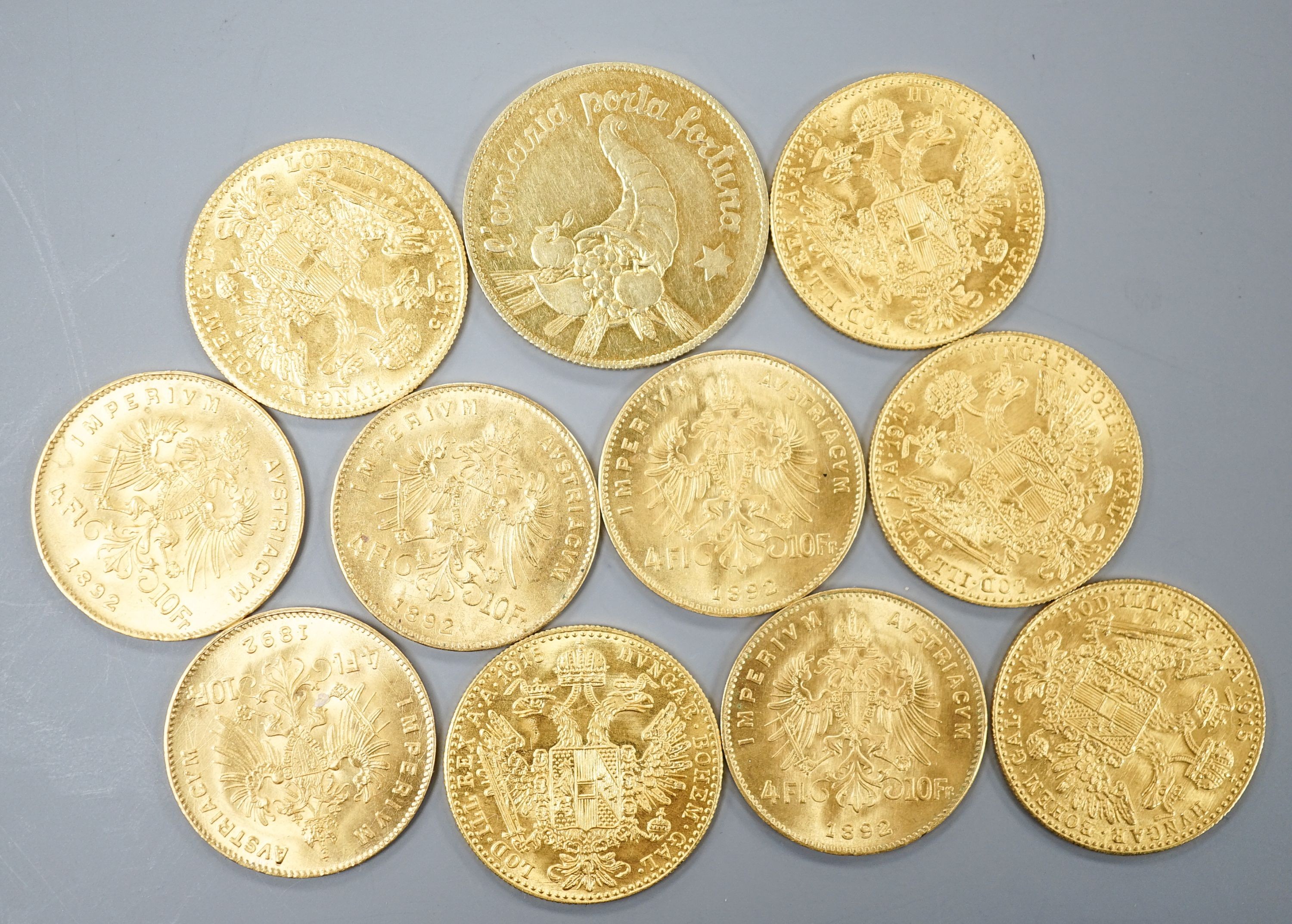 Ten Austrian gold Ducats (re-strikes) and an Italian 750 yellow metal 'I Star Lina de Amicizia'